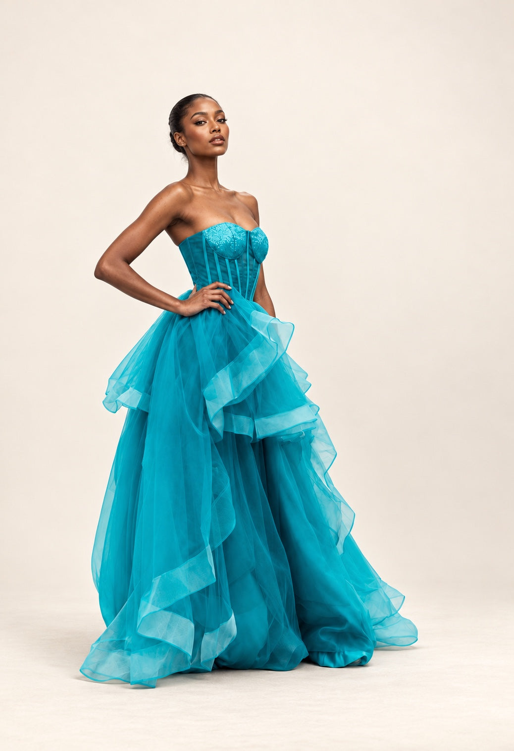 DivineWear turquoise strapless corset gown with cascading organza ruffles