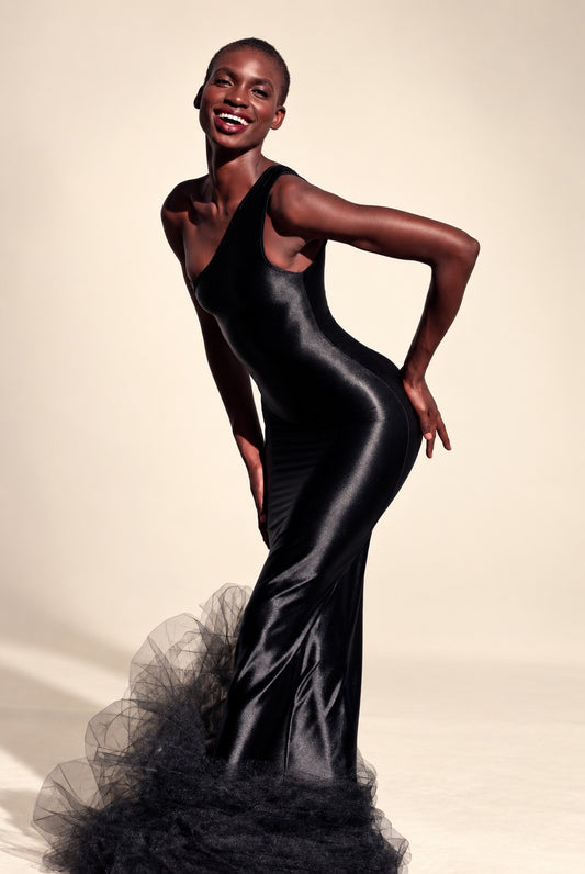 Black sleeveless fitted gown with a V neckline and gathered tulle hem