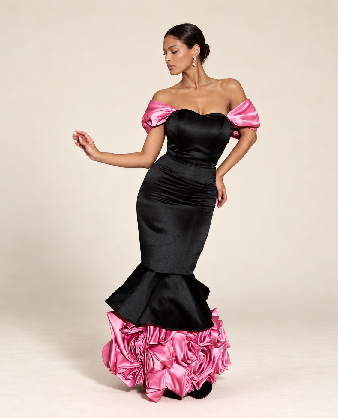 DivineWear black satin mermaid gown with pink off-shoulder sleeves and pink rosette hem