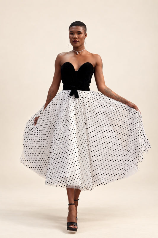 Strapless black sweetheart bodice with waist bow and white tulle midi skirt with black polka dots