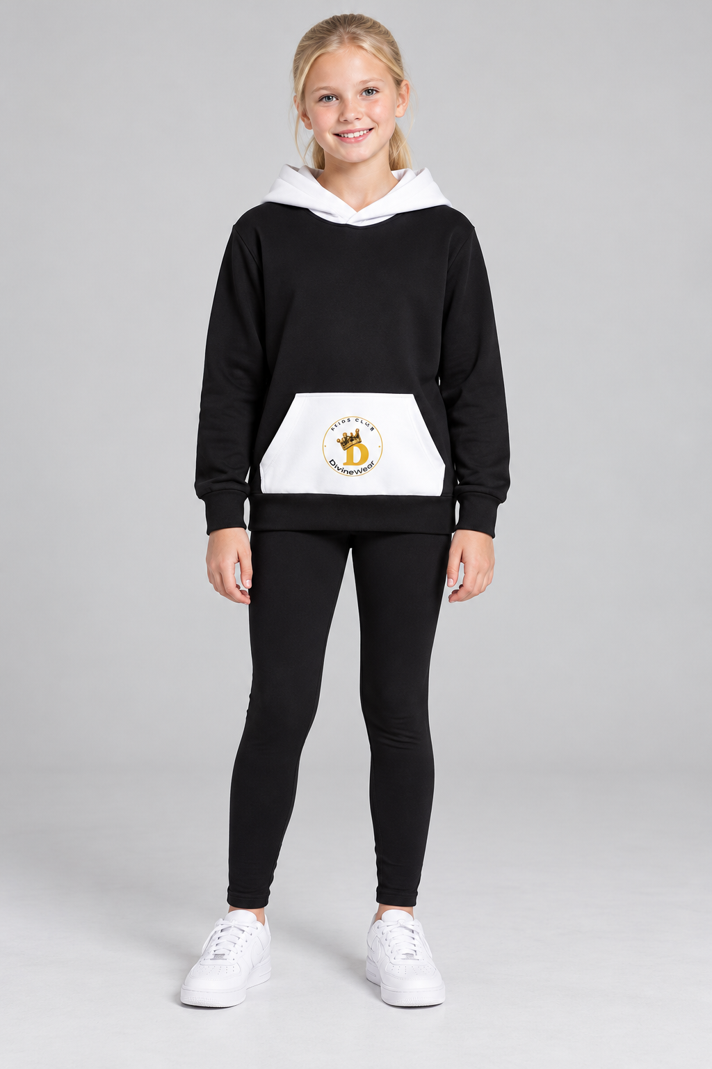 Blonde European youth model wearing the DivineWear Imperial Court hoodie with black leggings