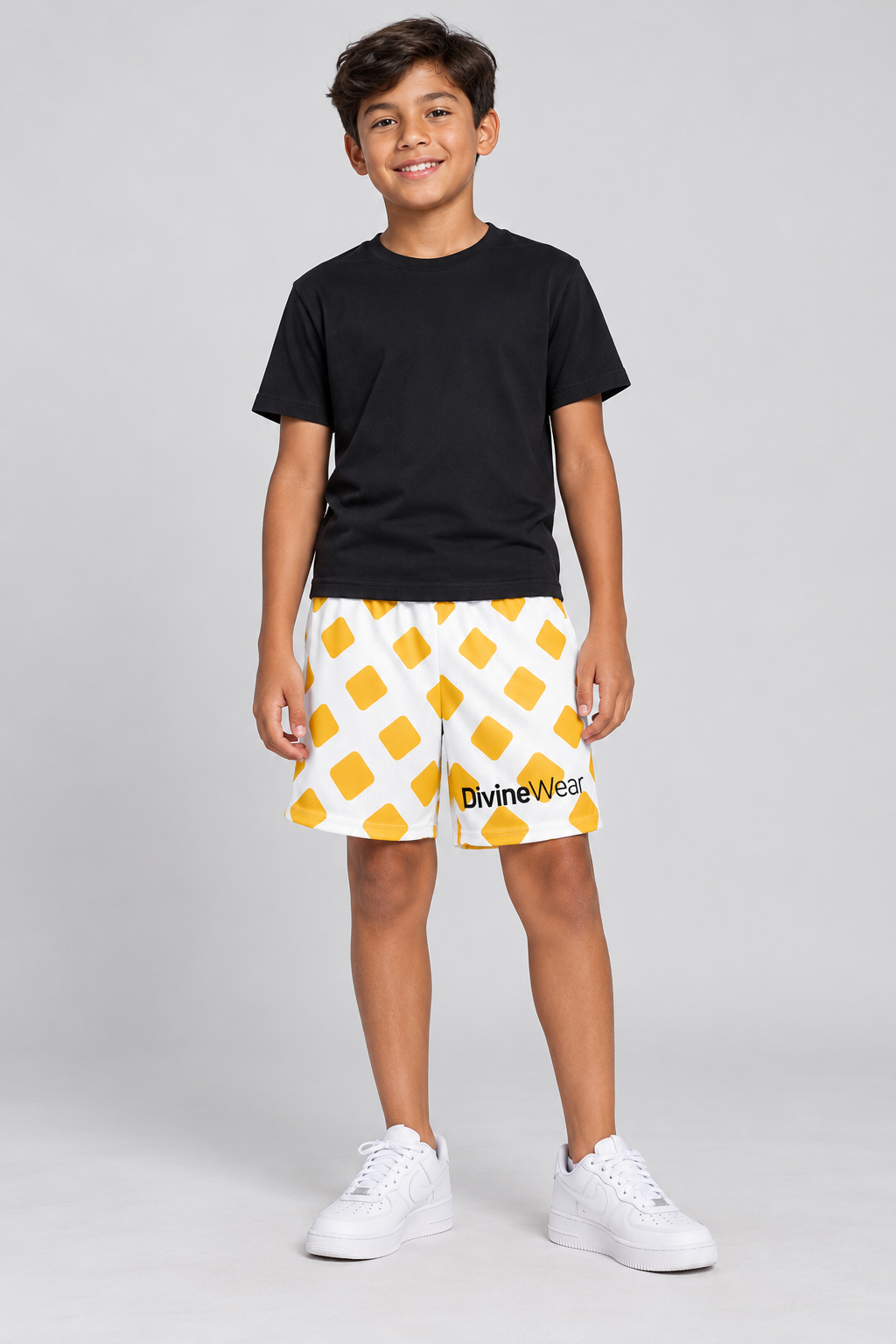 Mexican youth model wearing DivineWear white and yellow mesh shorts with a solid black tee