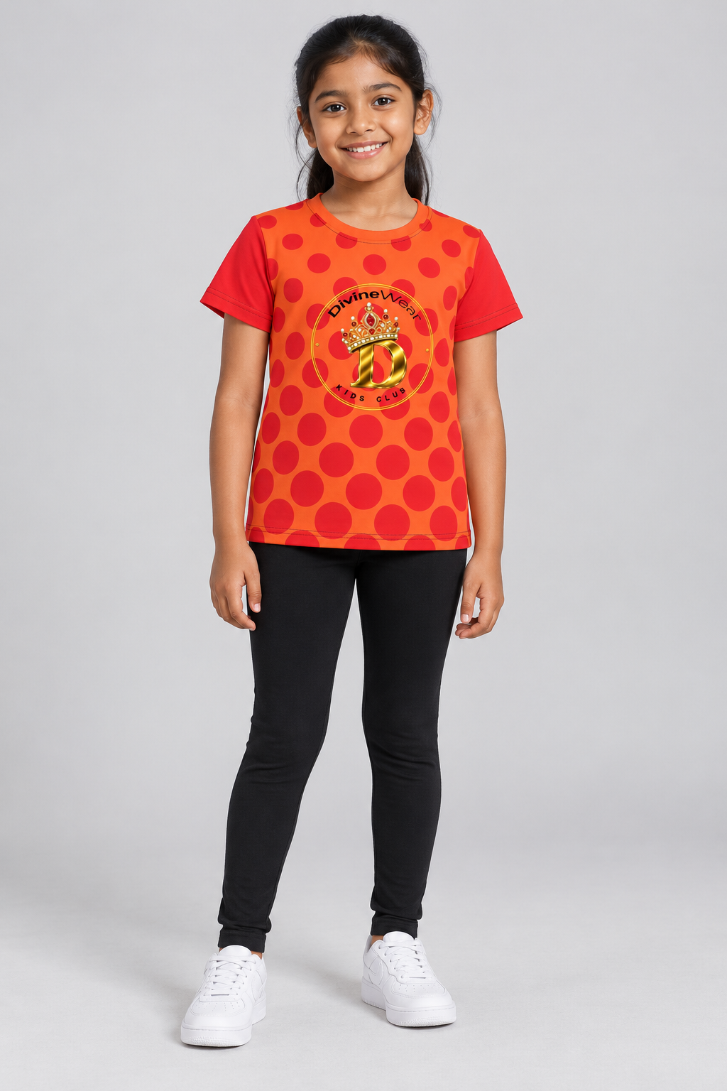 East Indian youth model wearing the DivineWear Kids Club Polka Dream tee with black leggings