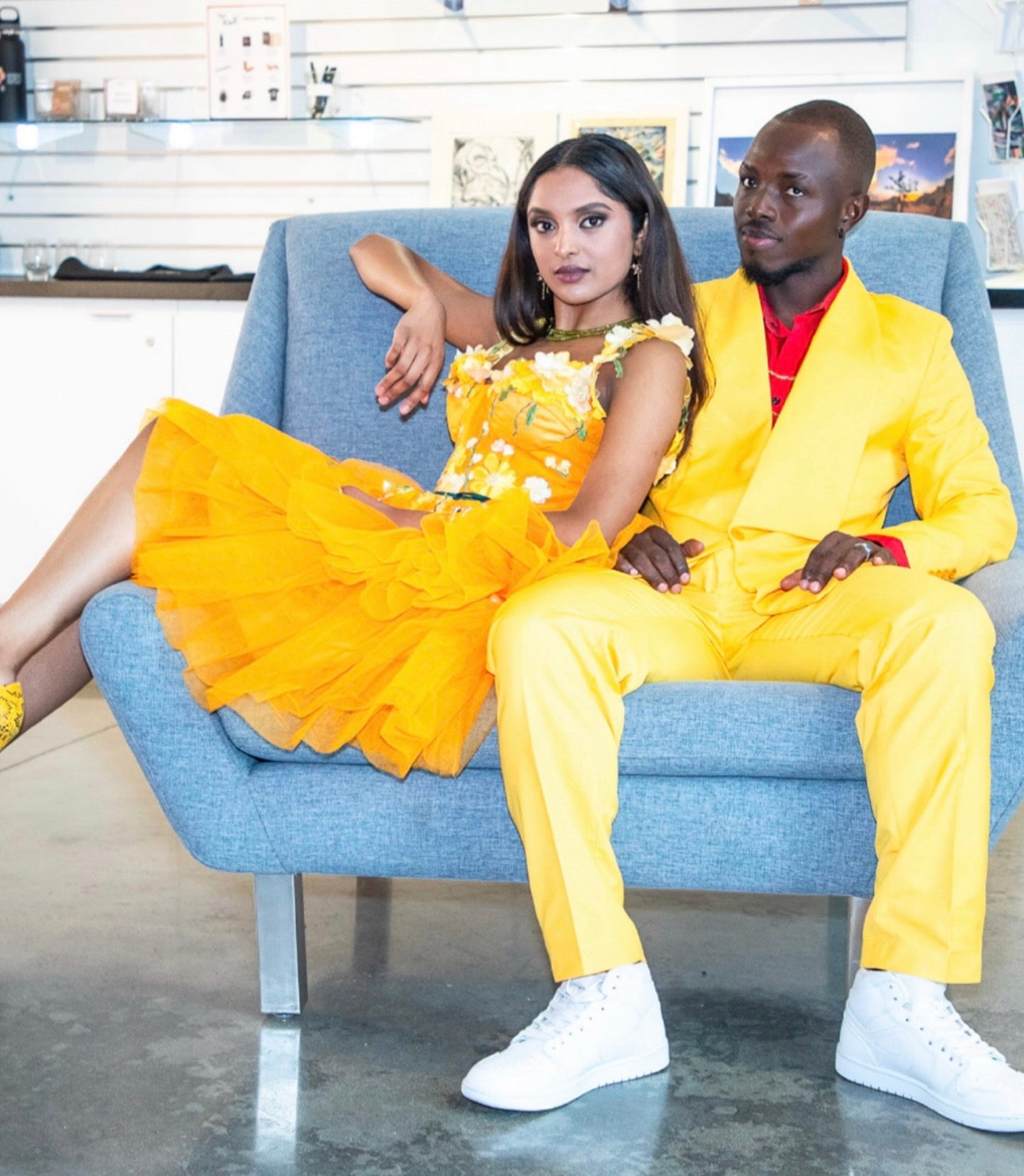 DivineWear editorial featuring two models in yellow and orange looks seated together