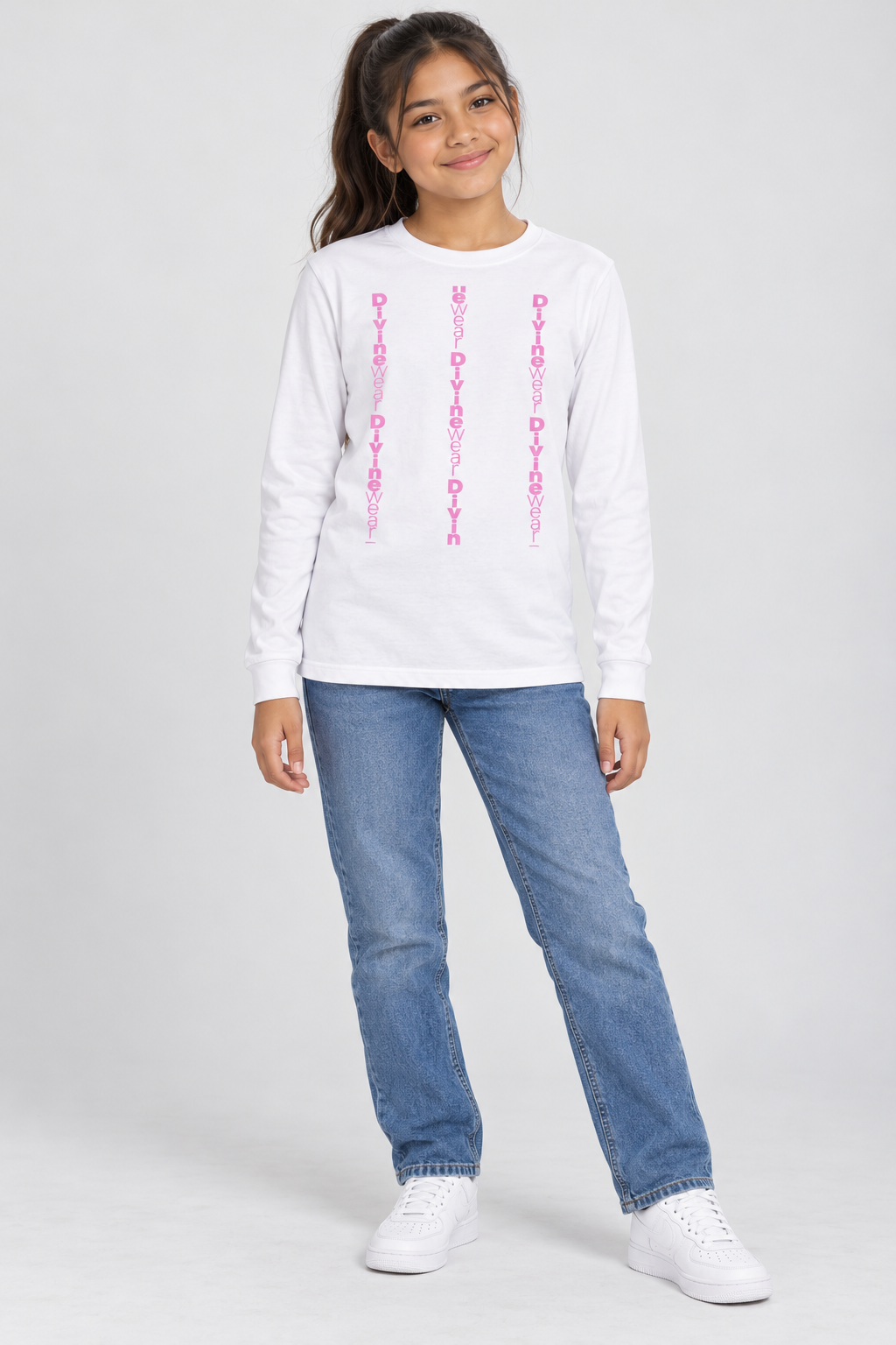 Latina youth model wearing the white DivineWear Kids Club Pretty in Pink long sleeve tee