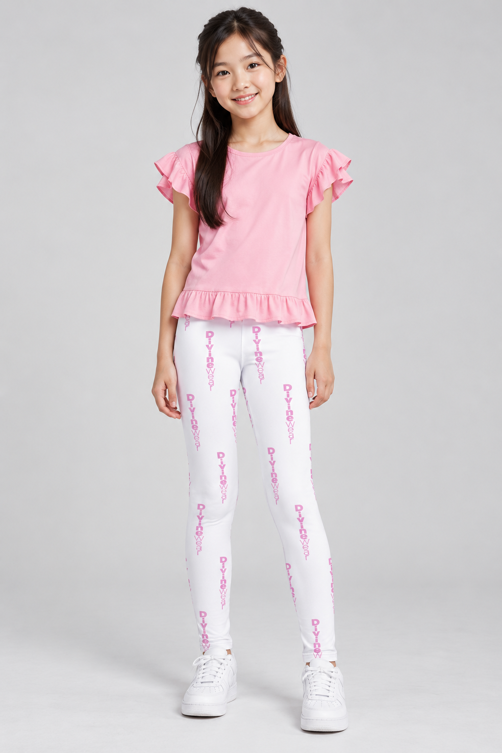 Korean youth model wearing DivineWear Pretty in Pink printed leggings styled with a pink frilly top