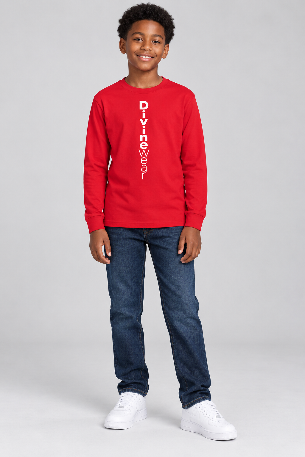 Ethiopian American boy modeling the red DivineWear Kids Club long sleeve tee