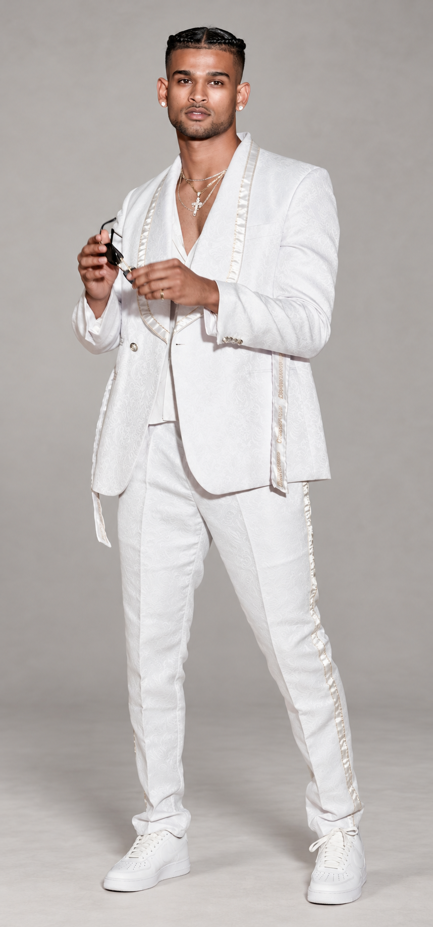 DivineWear white ribbon-trim runway suit on the original male model in a clean studio setting