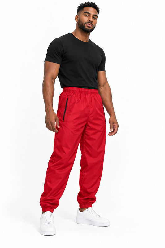 Trinidadian male model wearing DivineWear Dusk red unisex track pants